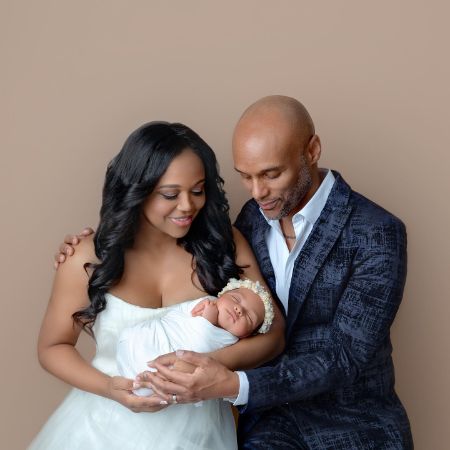 Kenny Lattimore Sr and his new wife Faith Jenkins holding their daughter Skylar. 